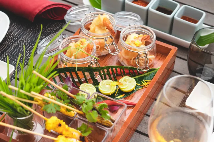 Shrimp appetizers in glass jars with garnishes at Sens Asia restaurant in Miramar Al Aqah Resort