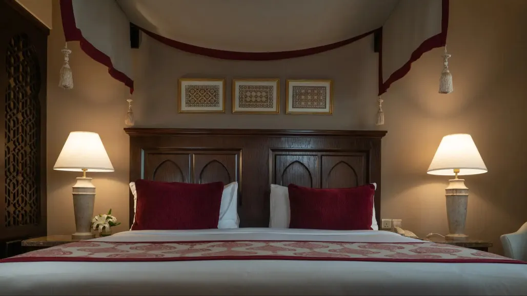 A queen size bed at the Al Dana Suite in Miramar Al Aqah Beach Resort